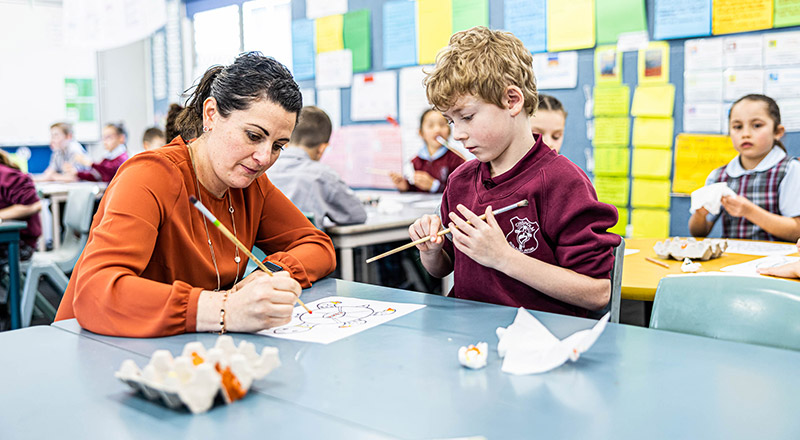 Teacher helping student at Chisholm Catholic Primary Bligh Park