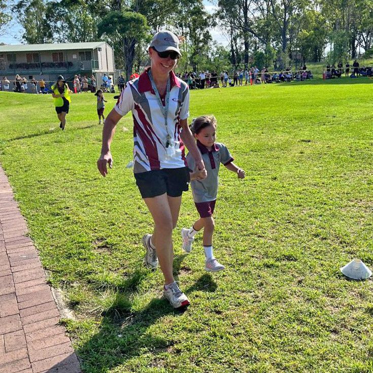 Teacher with student at Chisholm Catholic Primary Bligh Park Cross Country
