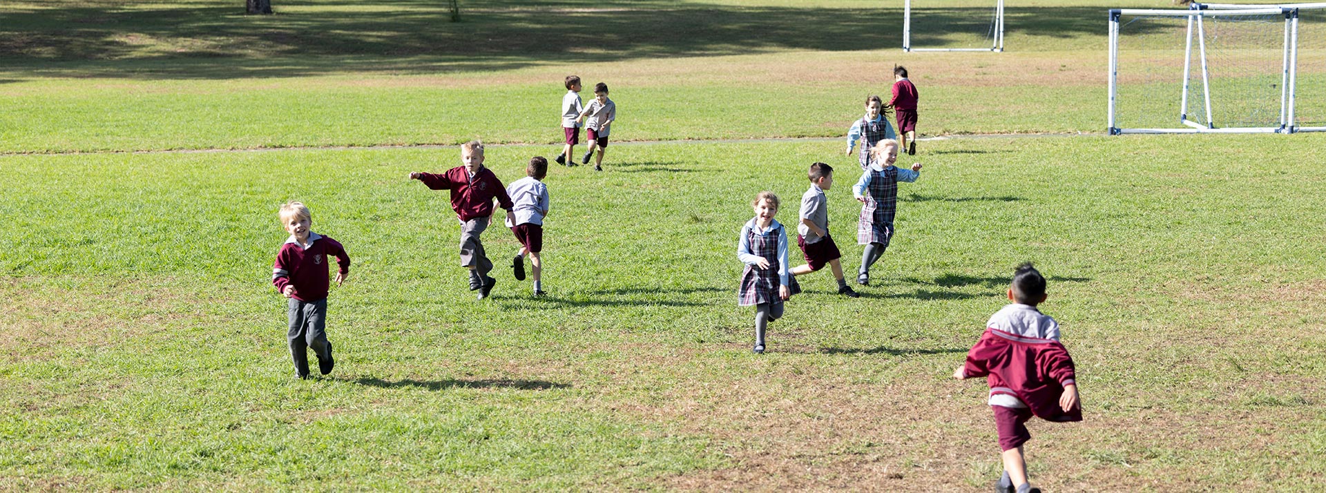 Chisholm Catholic Primary Bligh Park students playing on outdoor field