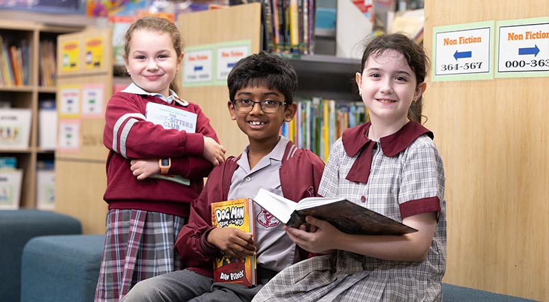 Three students sitting in library