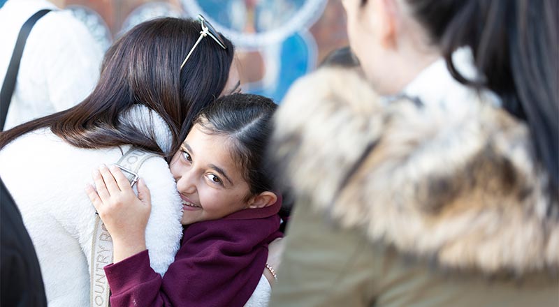 Student hugging mum