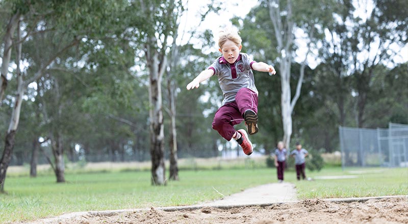 Student performing long jump
