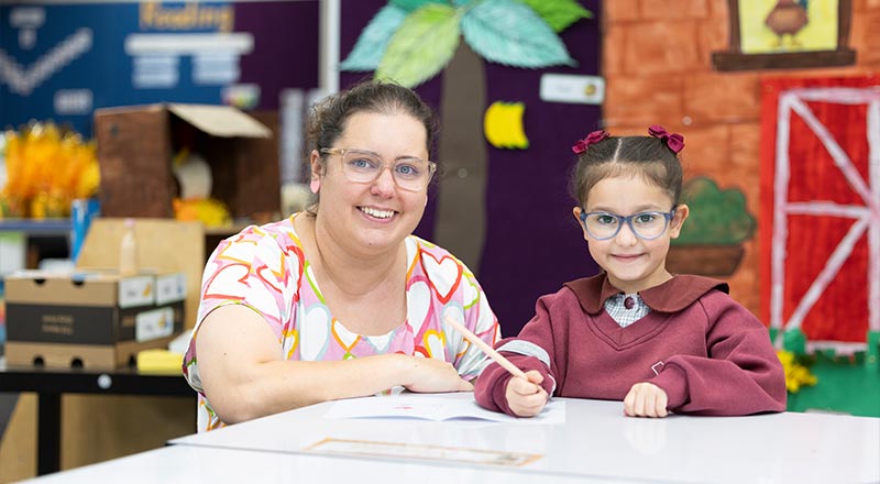 Teacher supporting a student in class