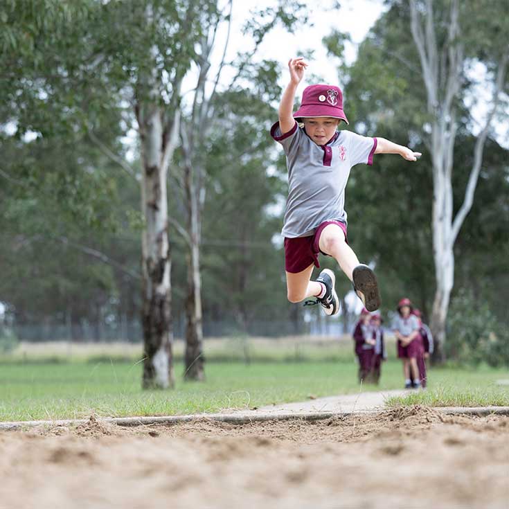 Student performing long jump