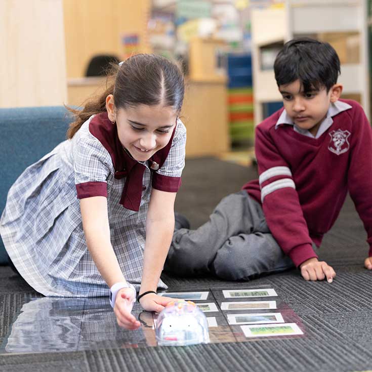 Two students playing with educational toy