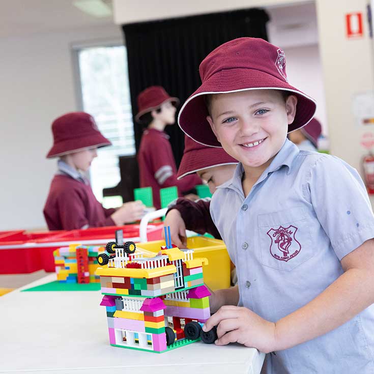 Student putting together a lego creation